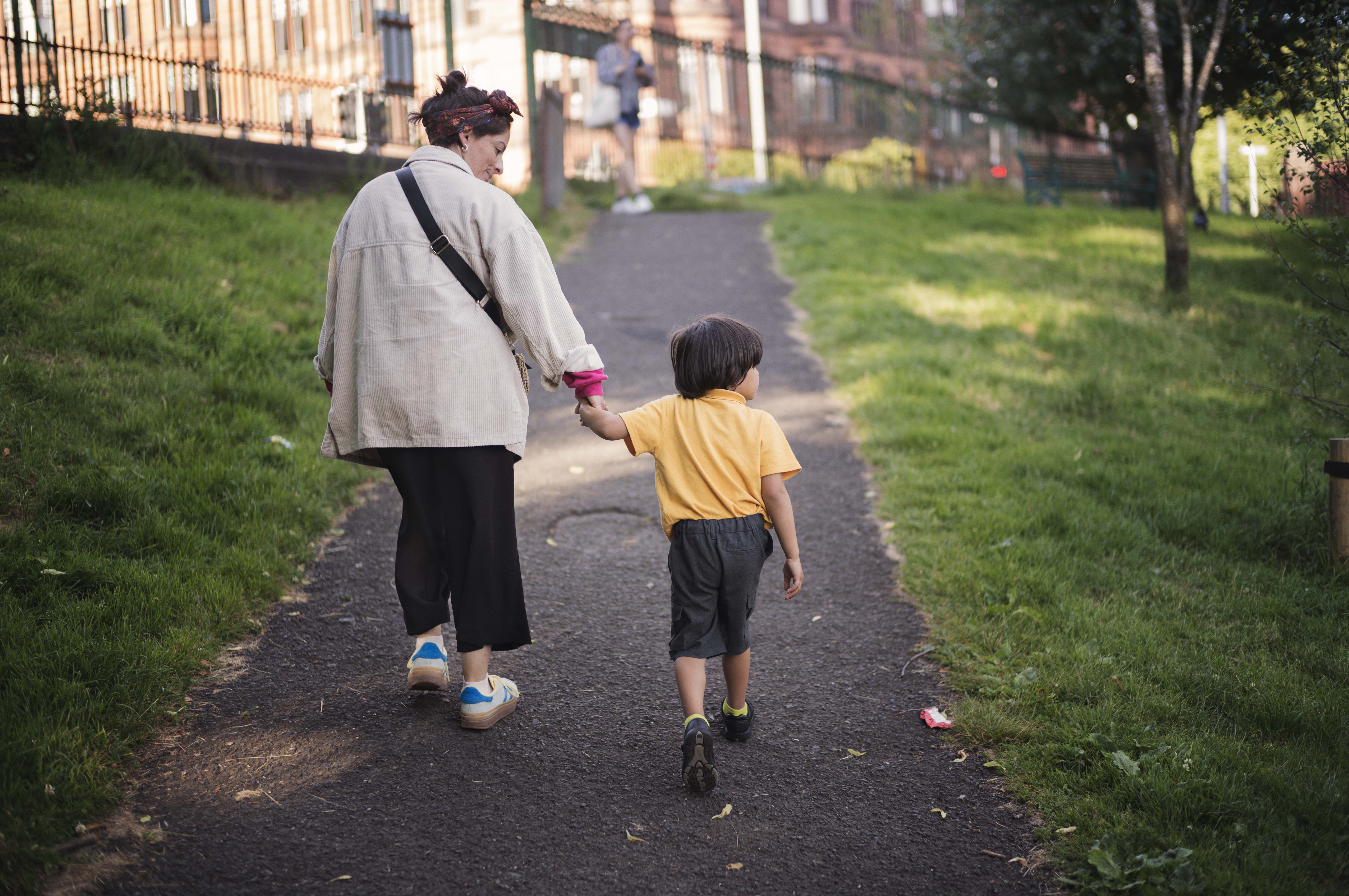 Mother and child walking together hand in hand