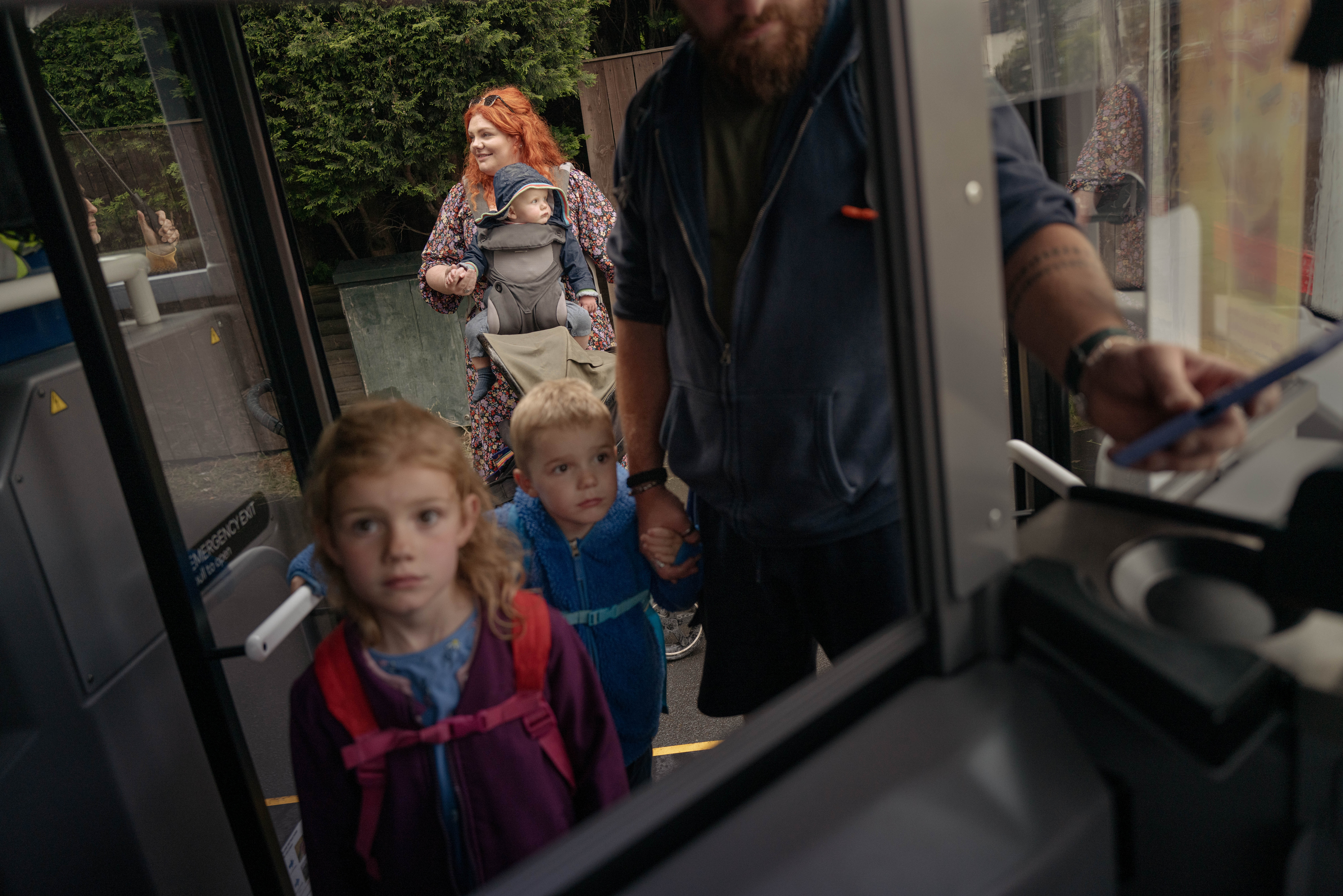 Family boarding a First Bus and paying with the driver