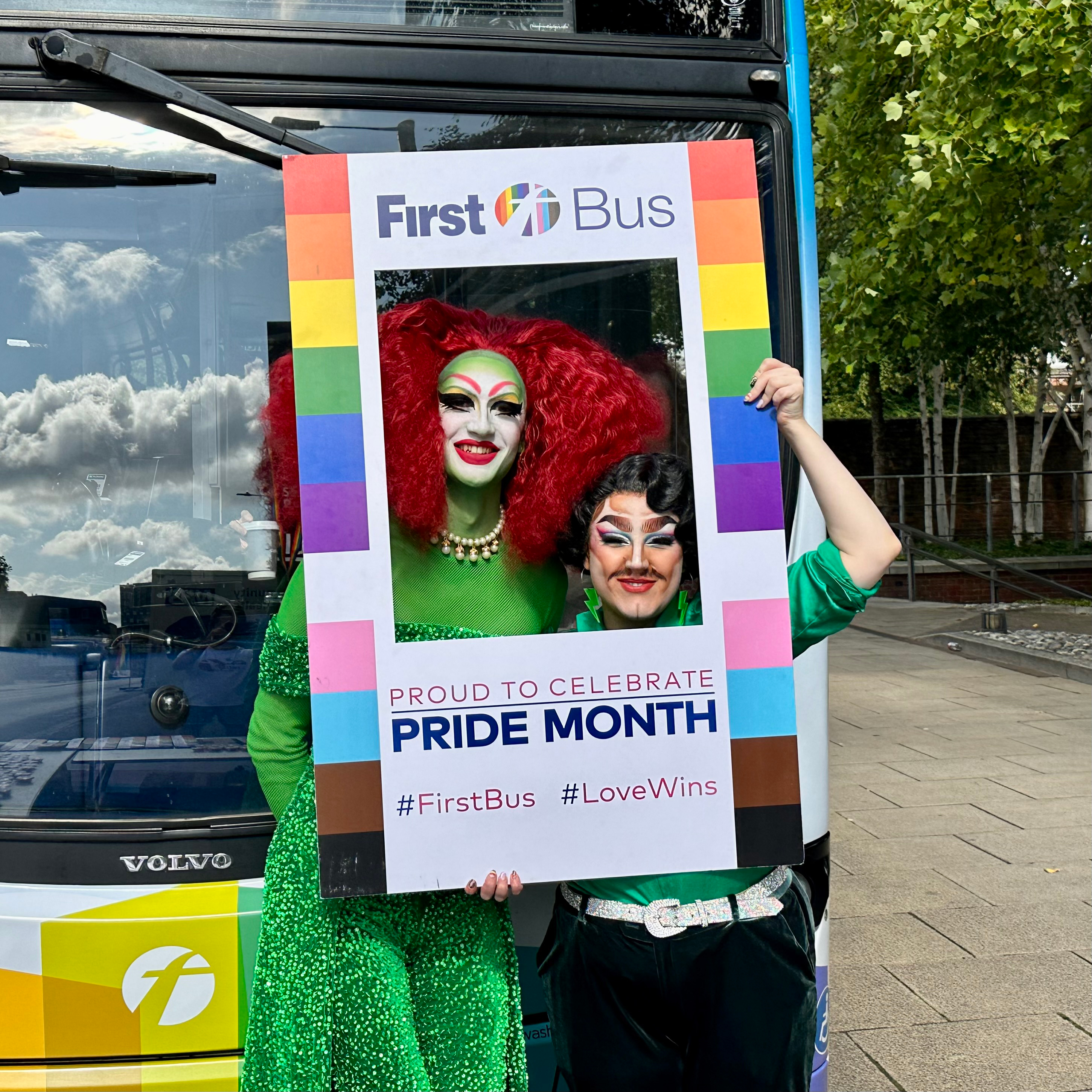 Drag queen Jester Mirage and drag king Will Power posing with the bus at the Norwich Pride event.