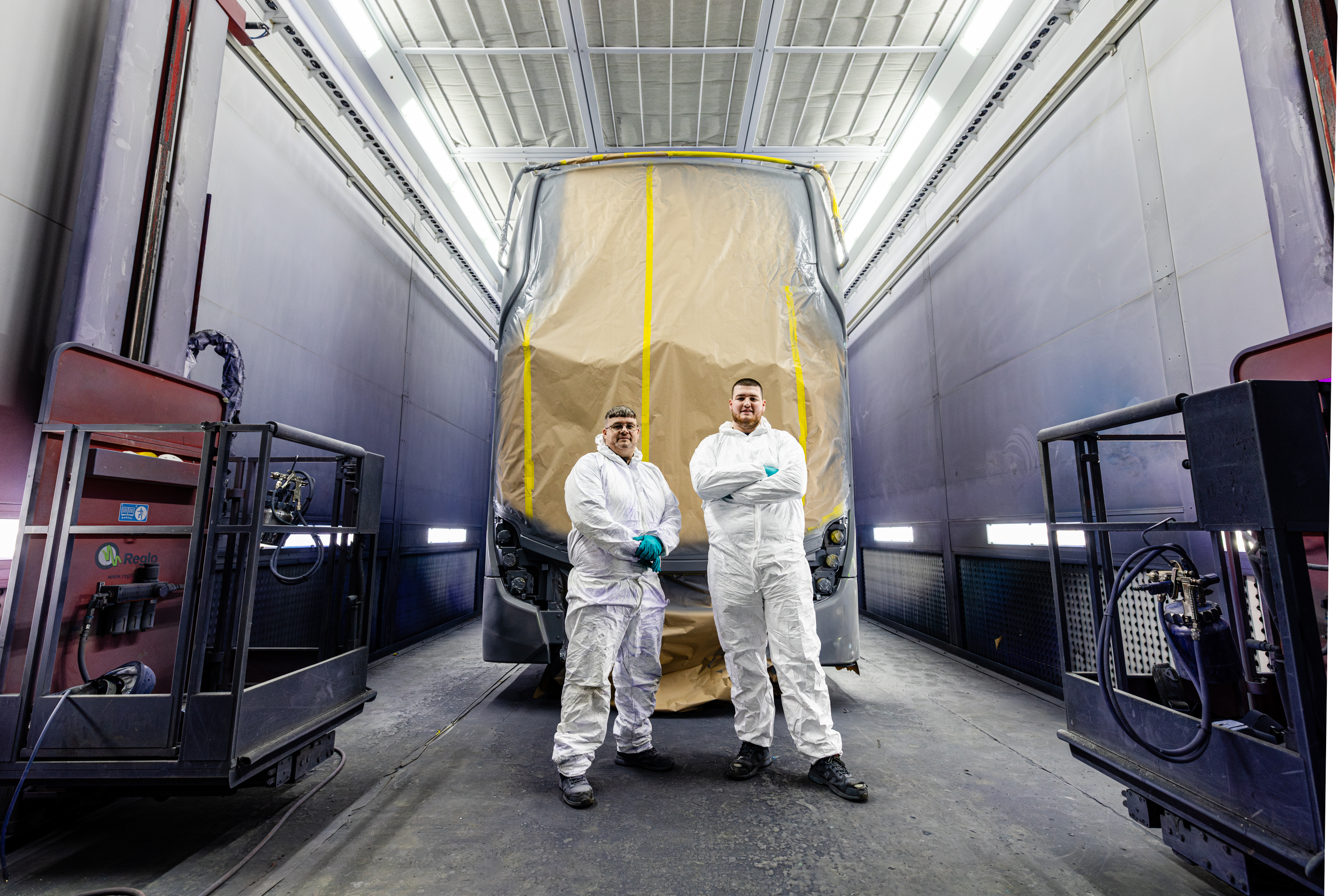 Colleagues stood in front of masked up bus