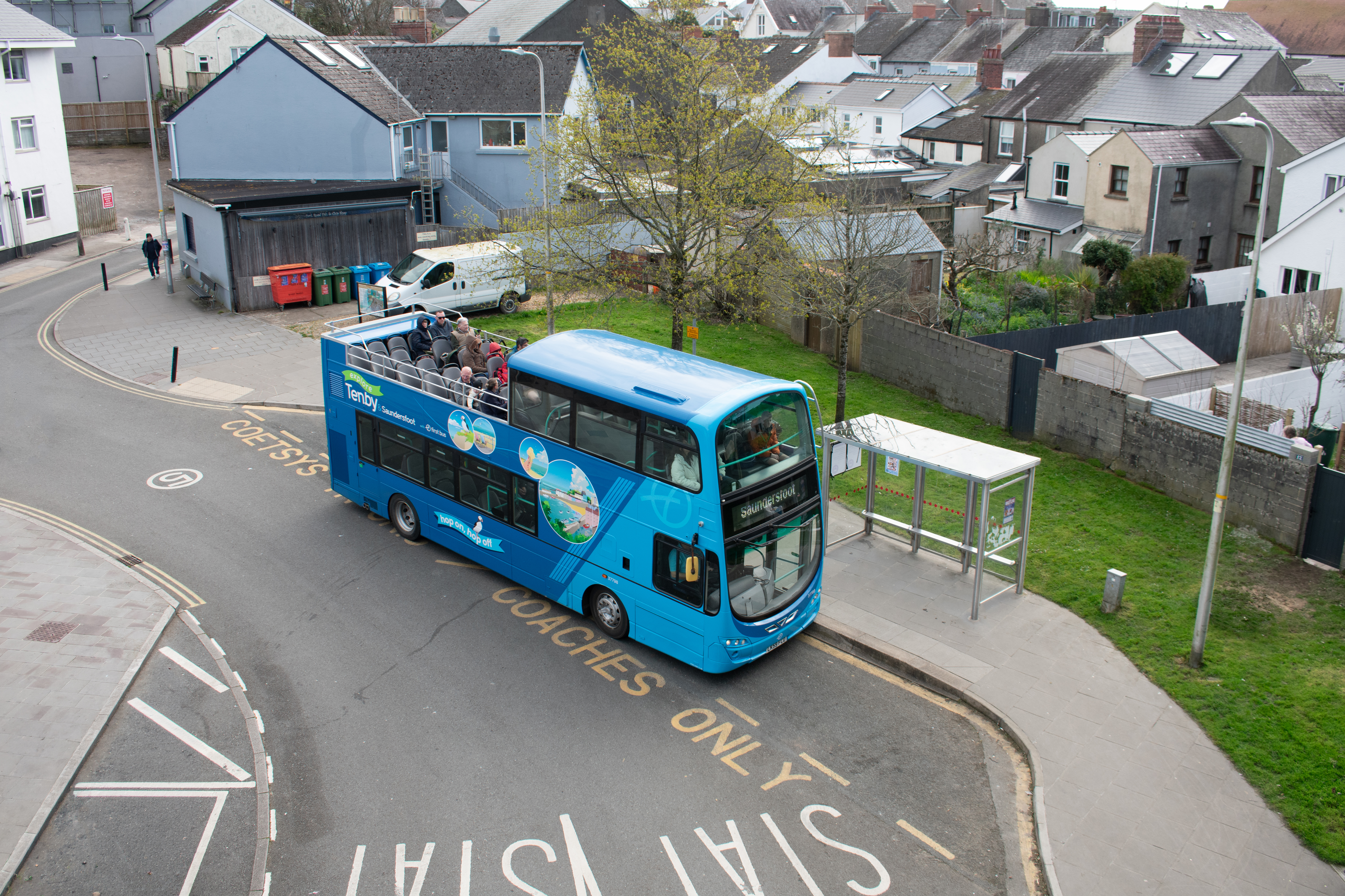the open-top bus at a bus stop in Tenby